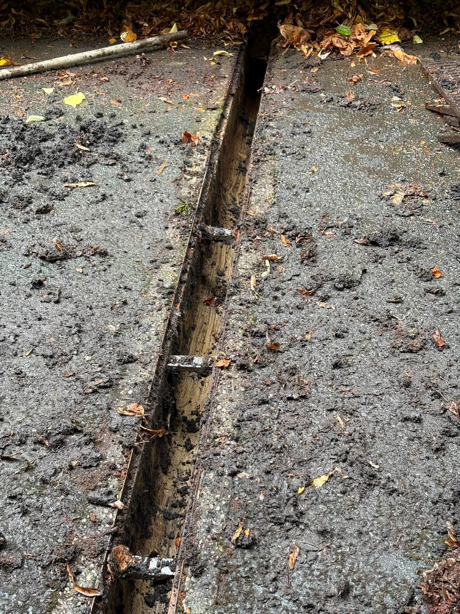 Drainage gulley cleared out of all the dirt, leaves and debris