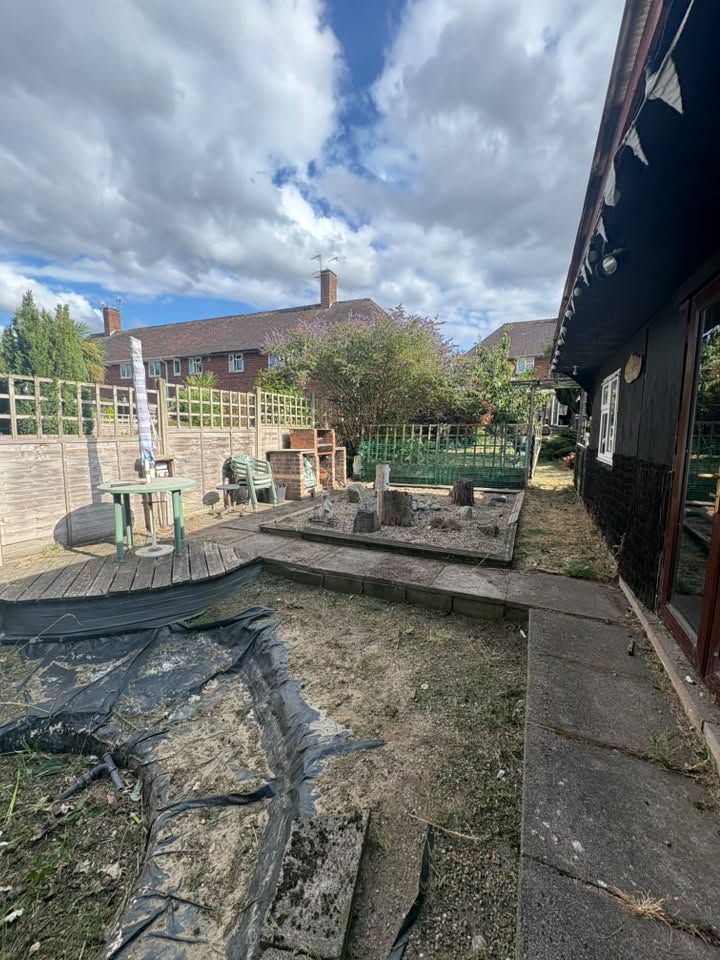 A garden tidy-up, clearing away overgrown plants and unwanted growth, revealing a sunken pit below.