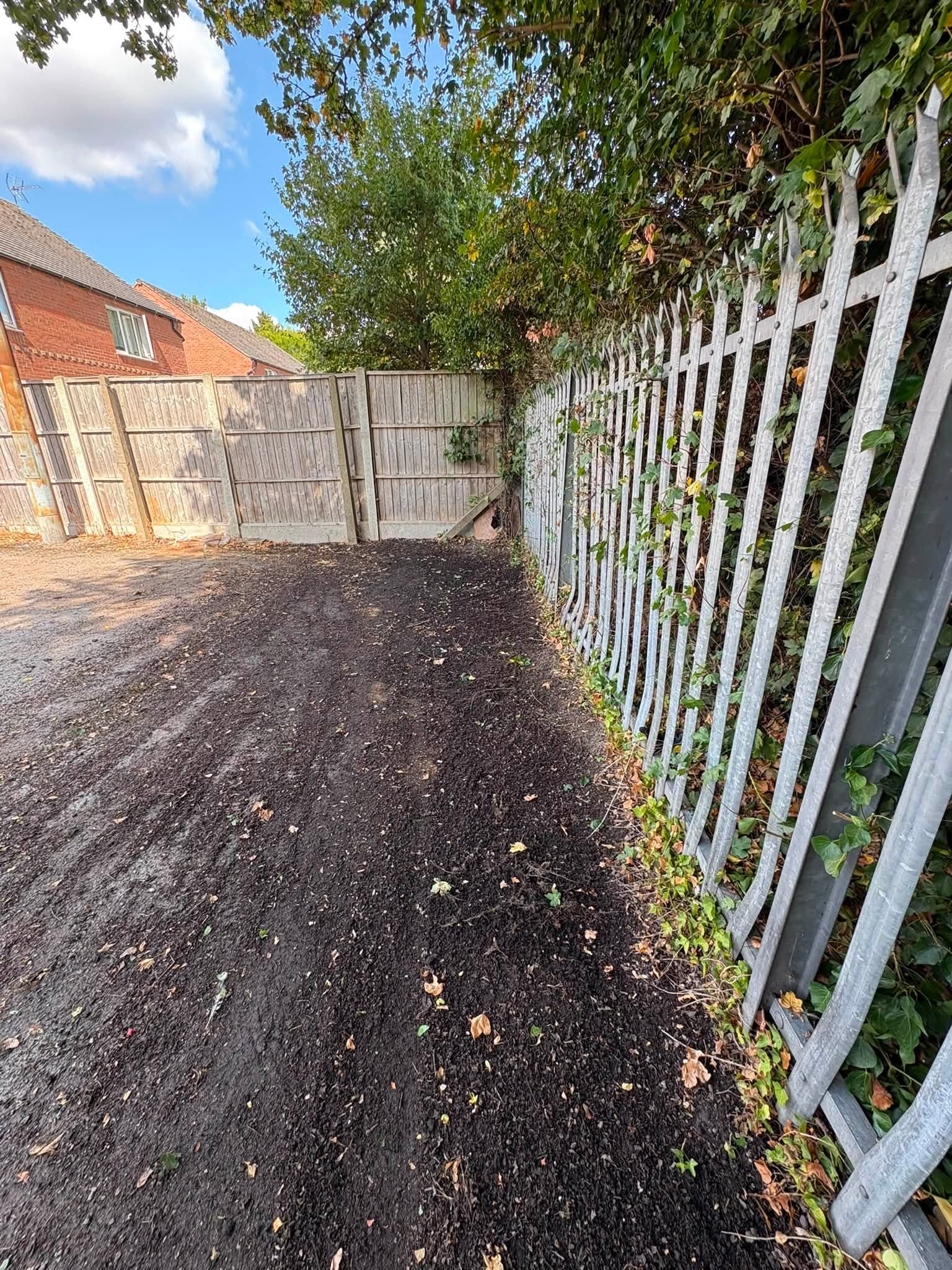 The bottom end of a car park has been cleared of heavy overgrowth and mud.